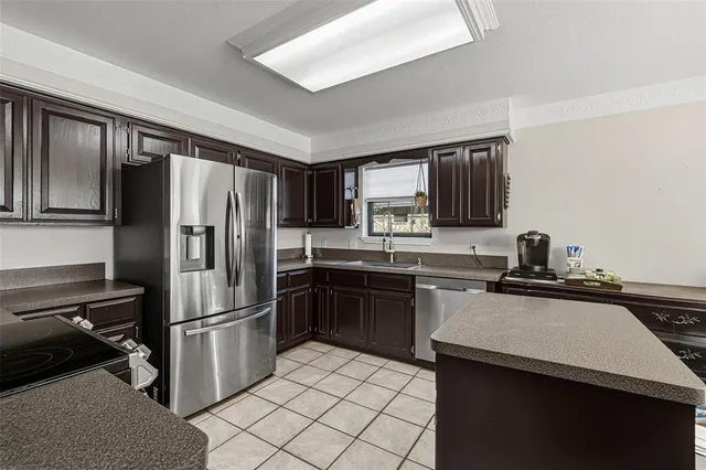 a kitchen with a refrigerator sink and microwave