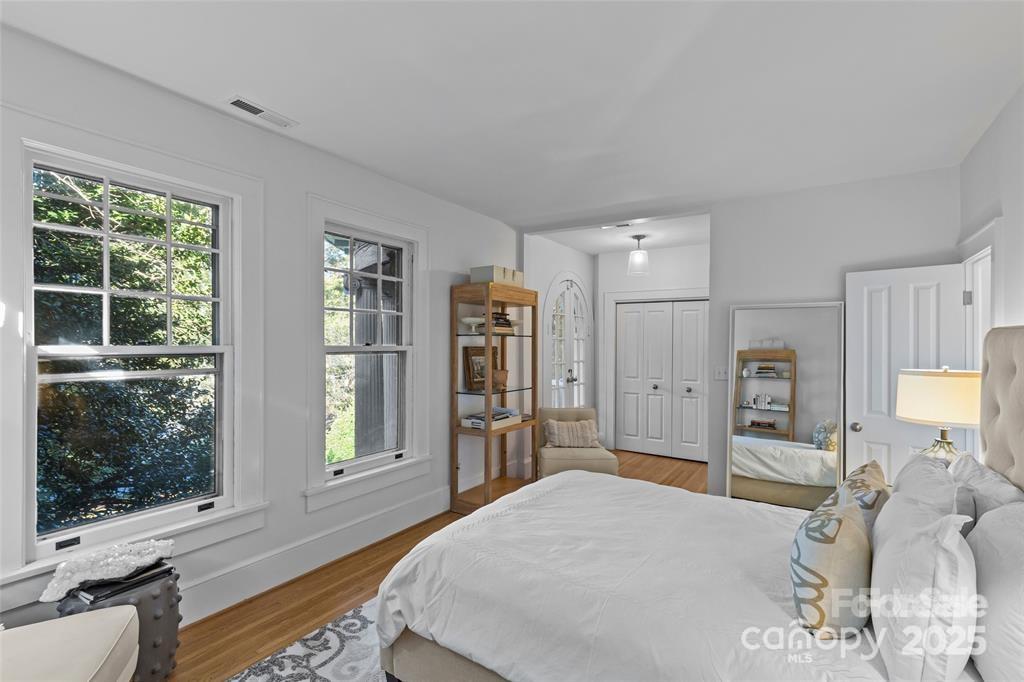 609 Queens Road, Unit A Charlotte, NC 28207 - Photo 16 of 34 a bed room with a bed window and a television