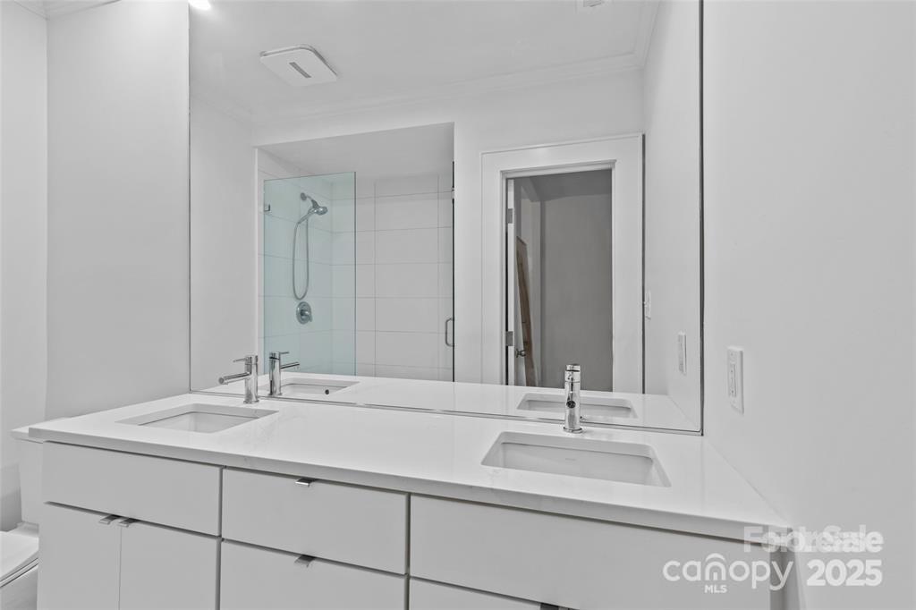 609 Queens Road, Unit A Charlotte, NC 28207 - Photo 20 of 34 a bathroom with a sink and a mirror