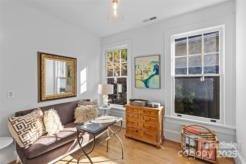 609 Queens Road, Unit A Charlotte, NC 28207 - Photo 22 of 34 a living room with furniture and a window
