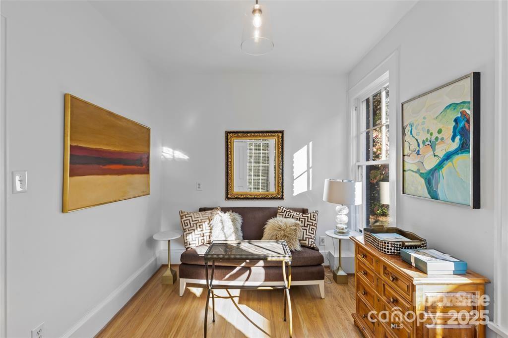 609 Queens Road, Unit A Charlotte, NC 28207 - Photo 23 of 34 a living room with furniture and a wooden floor