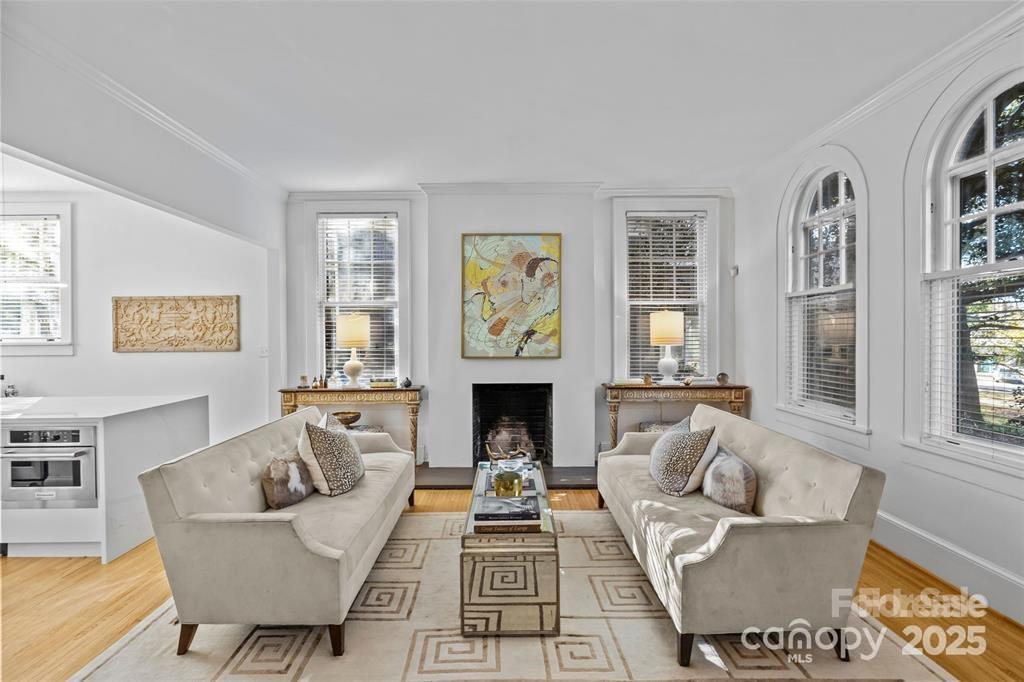 609 Queens Road, Unit A Charlotte, NC 28207 - Photo 9 of 34 a living room with furniture a fireplace and a window