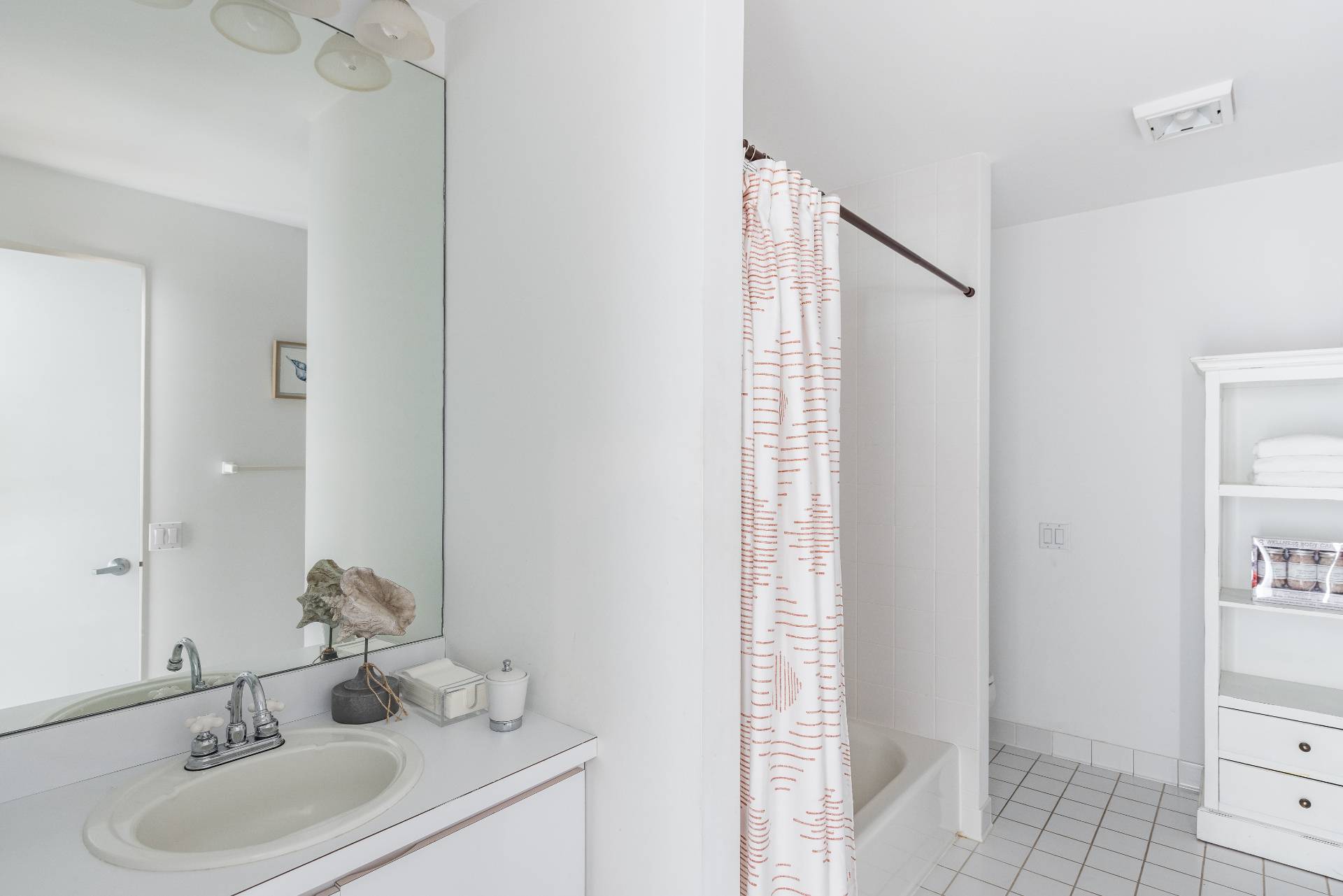 52 Bull Path East Hampton, NY 11937 - Photo 18 of 24 a bathroom with a sink and a mirror