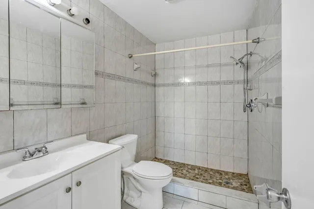 a view of an empty room with window and a ceiling fan