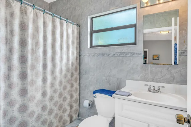 a bedroom with a bed and a dresser in it