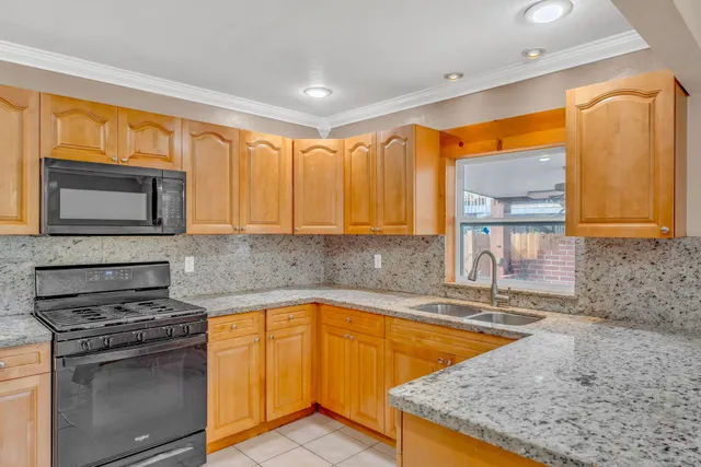 an empty room with kitchen view