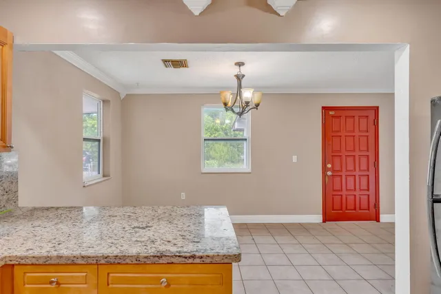 a kitchen with stainless steel appliances granite countertop a sink a stove and a microwave