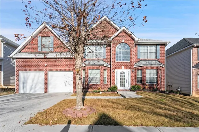 a front view of a house with a yard