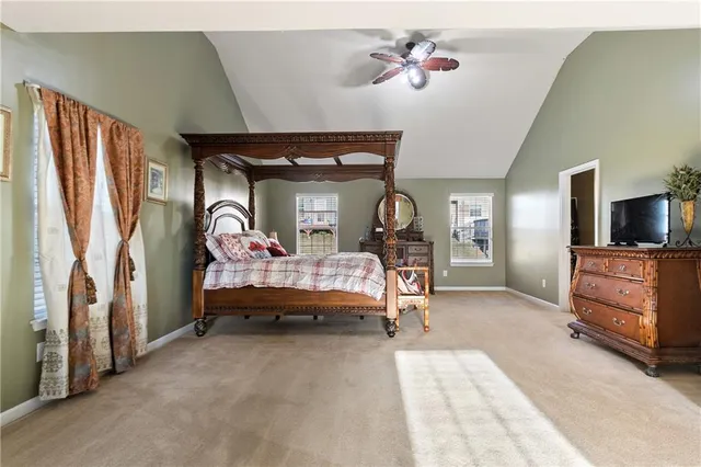 a bedroom with furniture and a mirror