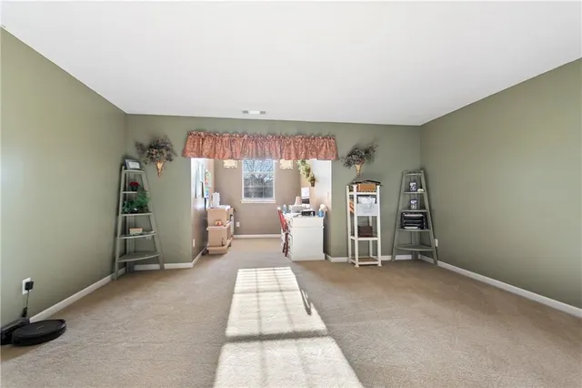 a view of a livingroom with furniture and a window
