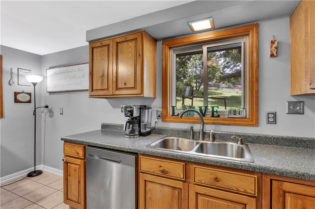 391 Wendel Road Irwin, PA 15642 - Photo 13 of 32 a kitchen with stainless steel appliances granite countertop a sink a refrigerator and cabinets