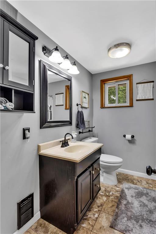 391 Wendel Road Irwin, PA 15642 - Photo 17 of 32 a bathroom with a toilet sink and mirror