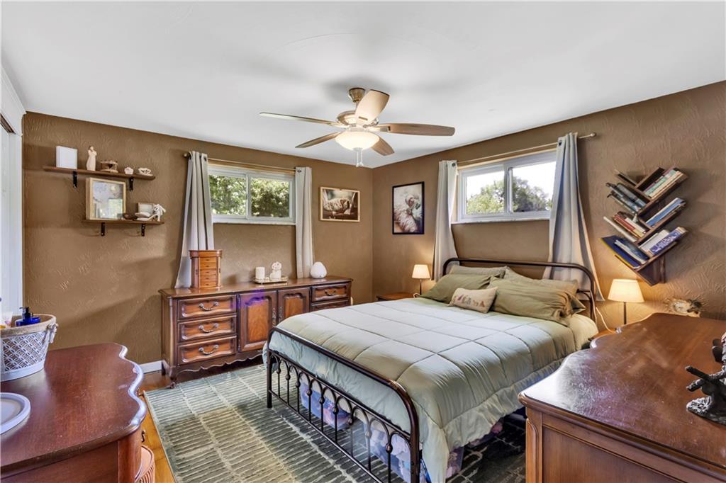 391 Wendel Road Irwin, PA 15642 - Photo 18 of 32 a bedroom with a bed and a chandelier with a flat tv screen