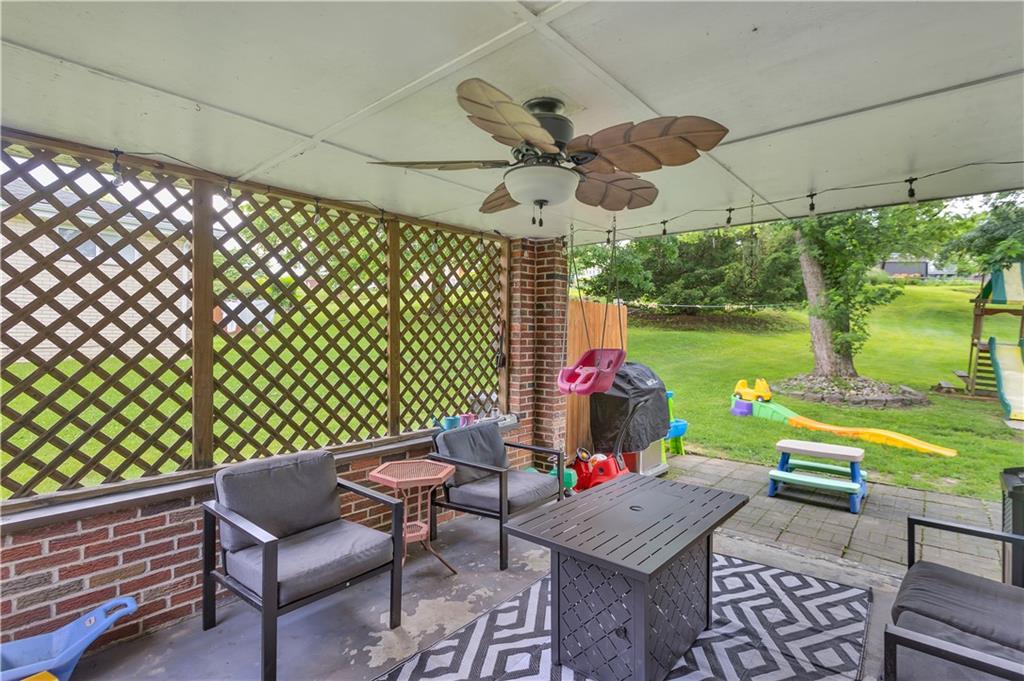 391 Wendel Road Irwin, PA 15642 - Photo 25 of 32 a view of a patio with table and chairs potted plants and palm tree