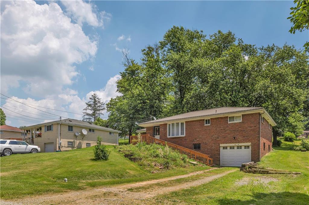 391 Wendel Road Irwin, PA 15642 - Photo 3 of 32 a view of a yard in front of a house