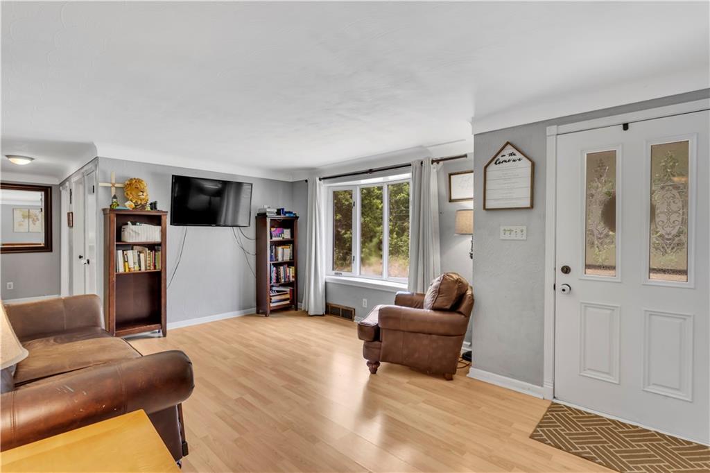 391 Wendel Road Irwin, PA 15642 - Photo 6 of 32 a living room with furniture and a flat screen tv