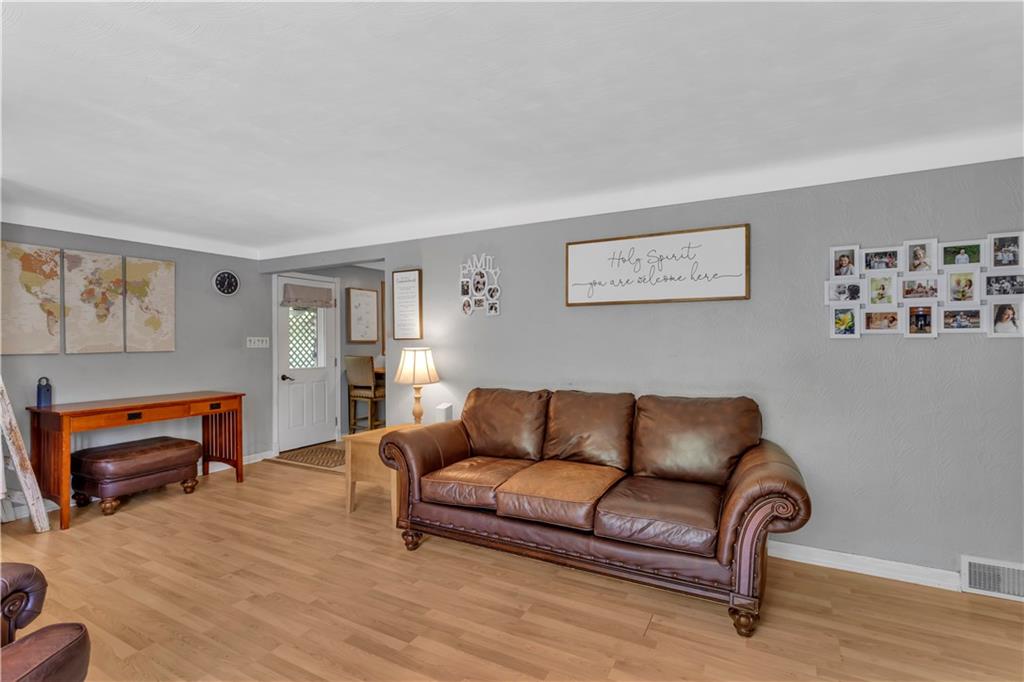 391 Wendel Road Irwin, PA 15642 - Photo 7 of 32 a living room with furniture and a wooden floor