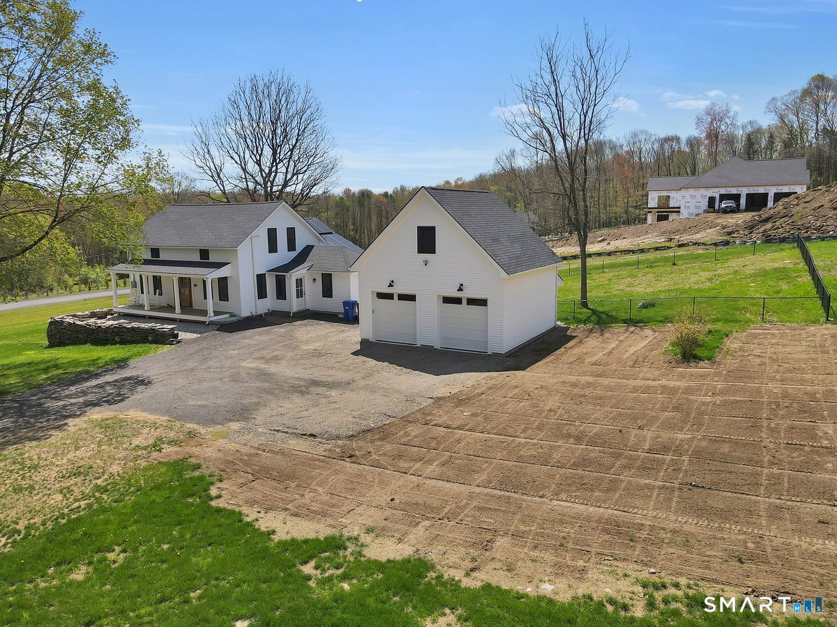 106 South Street Extension Coventry, CT 06238 - Photo 29 of 33 a front view of a house with a yard and garage