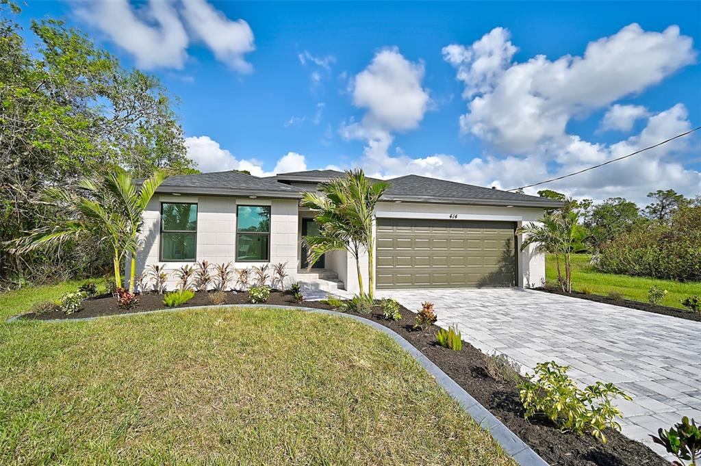 414 Sunset Road Rotonda West, FL 33947 - Photo 1 of 1 a front view of a house with garden