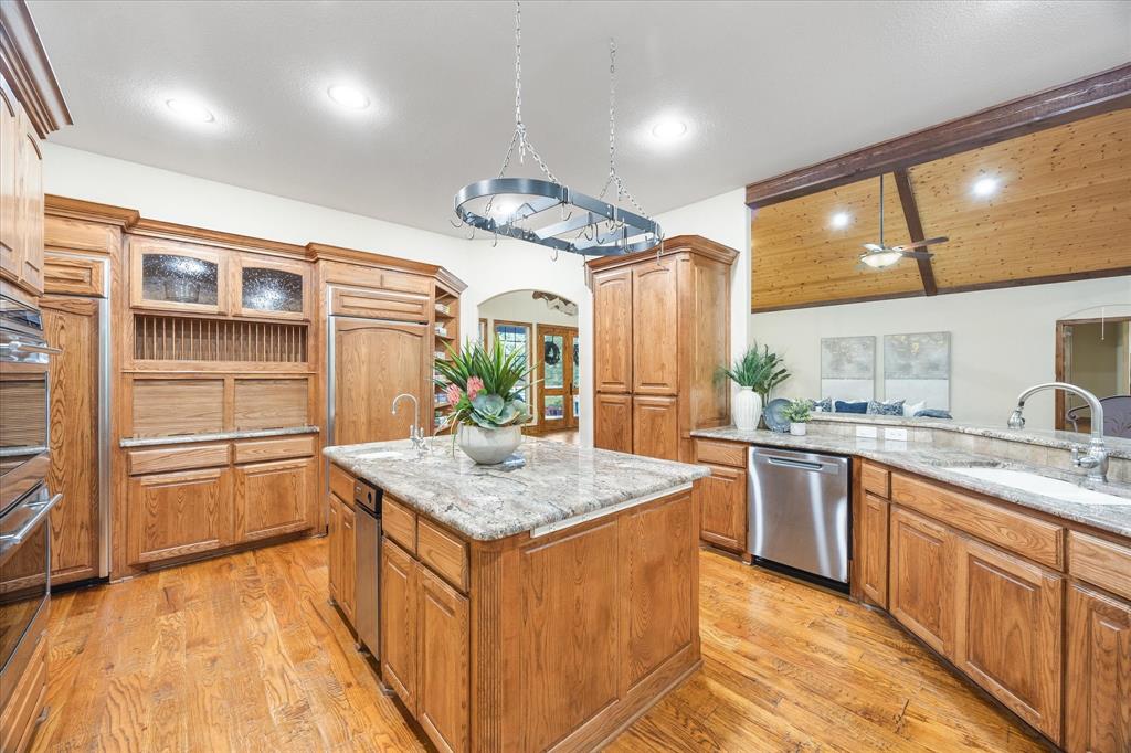 2702 Hidden Trails Road Royse City, TX 75189 - Photo 11 of 39 a kitchen with stainless steel appliances granite countertop a sink stove and refrigerator