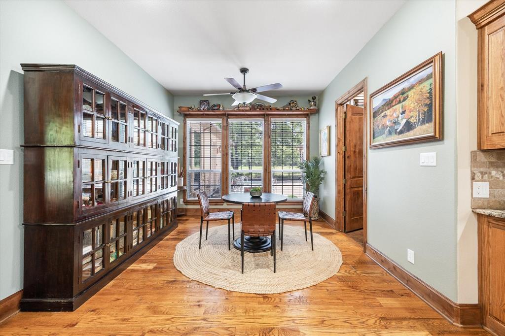 2702 Hidden Trails Road Royse City, TX 75189 - Photo 13 of 39 a dining room with wooden floor a chandelier a book and a table