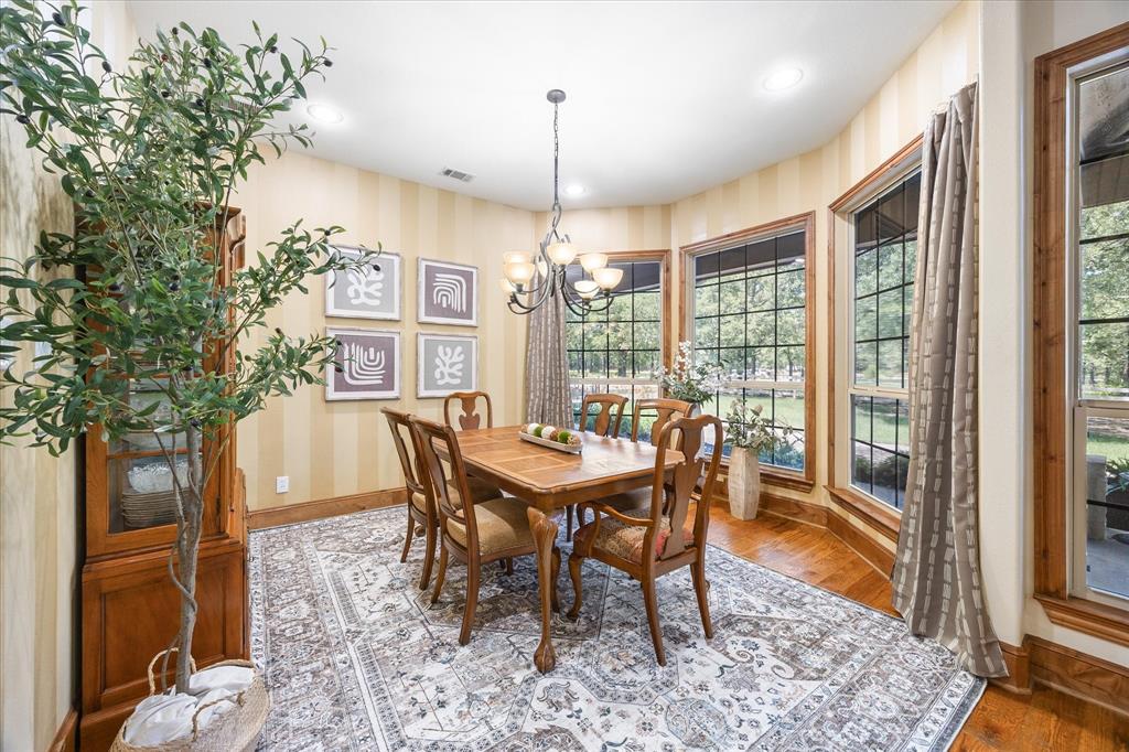 2702 Hidden Trails Road Royse City, TX 75189 - Photo 15 of 39 a dining room with furniture a chandelier and wooden floor