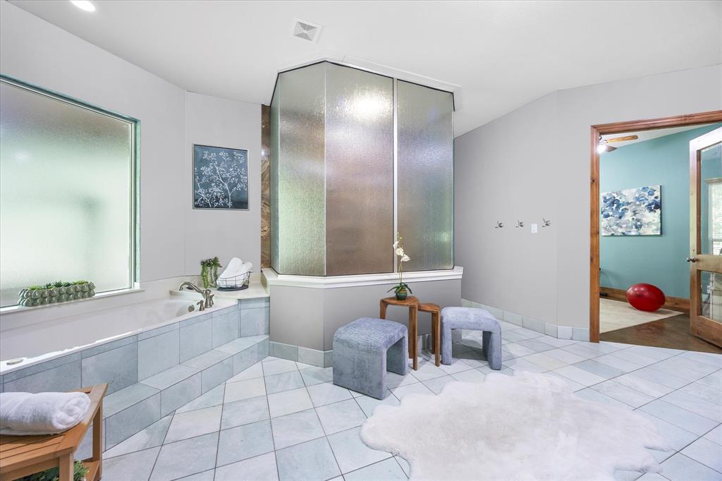 2702 Hidden Trails Road Royse City, TX 75189 - Photo 19 of 39 a bathroom with double vanity sinks a tub and a mirror