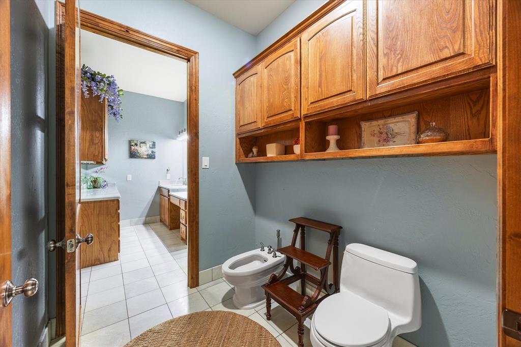 2702 Hidden Trails Road Royse City, TX 75189 - Photo 23 of 39 a bathroom with a toilet a sink and a mirror
