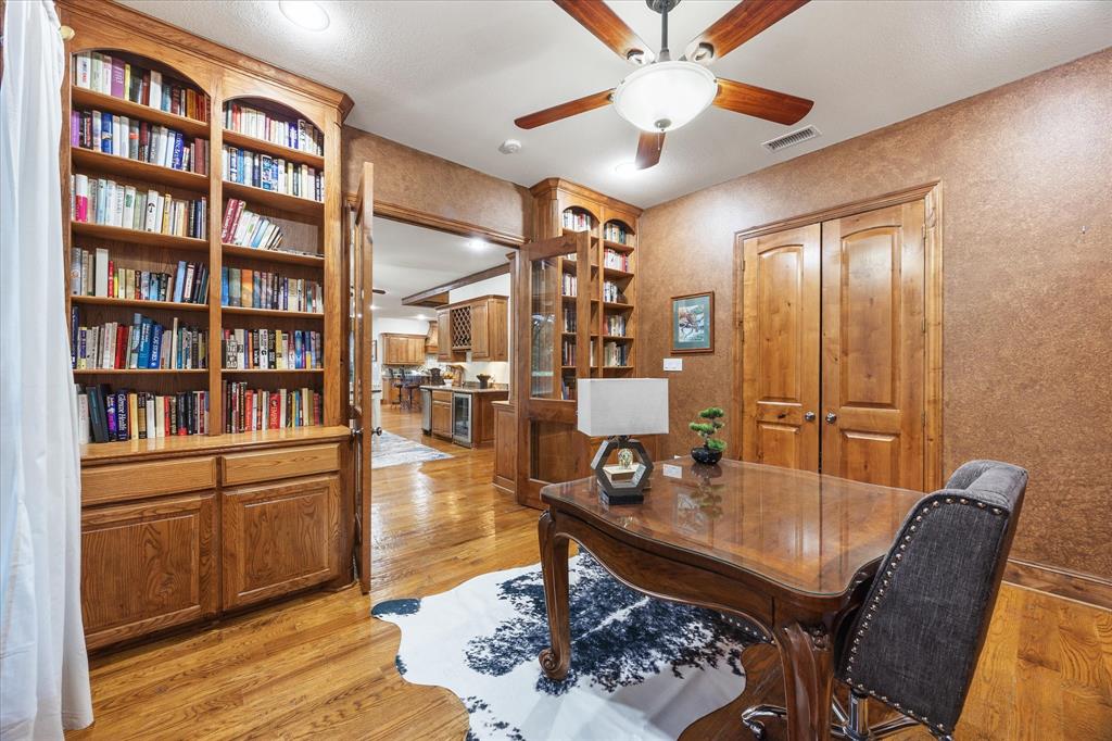 2702 Hidden Trails Road Royse City, TX 75189 - Photo 26 of 39 a living room with furniture a bookshelf and a book shelf