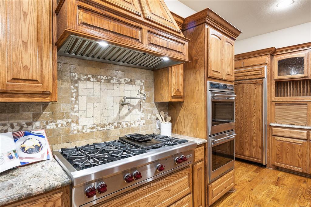 2702 Hidden Trails Road Royse City, TX 75189 - Photo 3 of 39 a kitchen with stainless steel appliances granite countertop a stove and a refrigerator