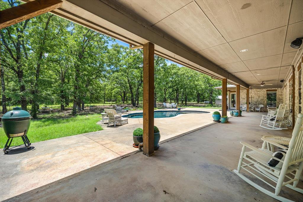 2702 Hidden Trails Road Royse City, TX 75189 - Photo 36 of 39 a view of a porch with chairs and backyard