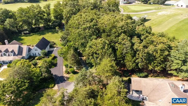 a view of a lush green hillside and a yard