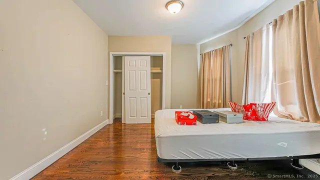 a living room with hard wood flooring and furniture