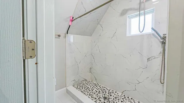 a bathroom with a shower a toilet and sink