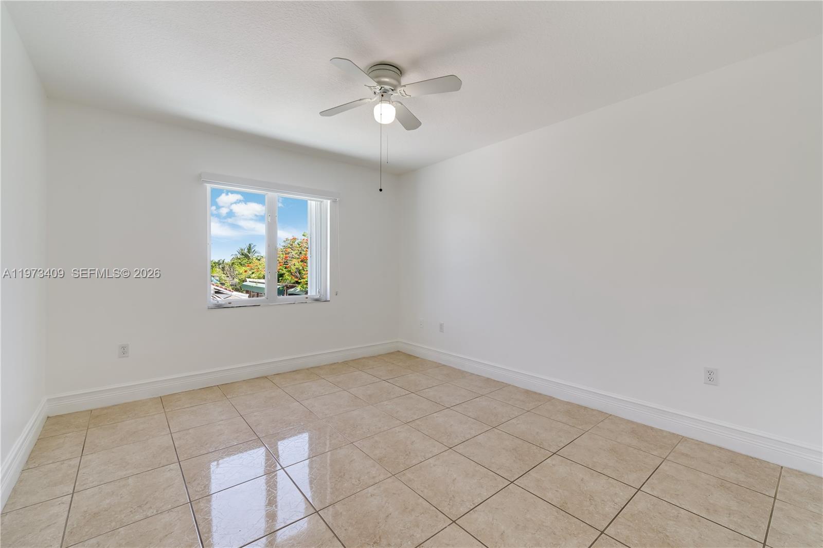 13050 Southwest 26th Street Miami, FL 33175 - Photo 16 of 43 an empty room with windows and ceiling fan