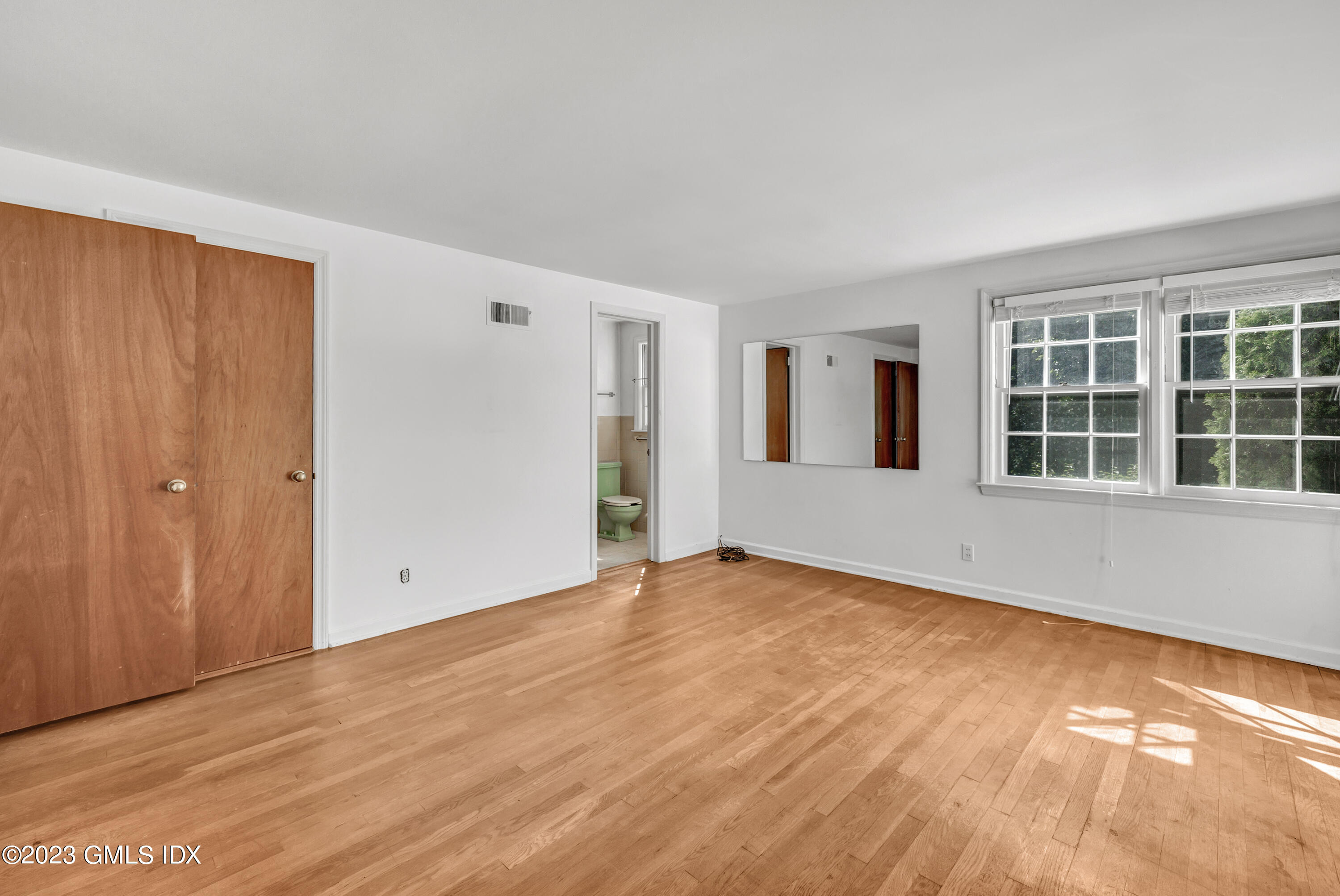 20 Bayside Terrace Riverside, CT 06878 - Photo 15 of 30 an empty room with wooden floor and windows
