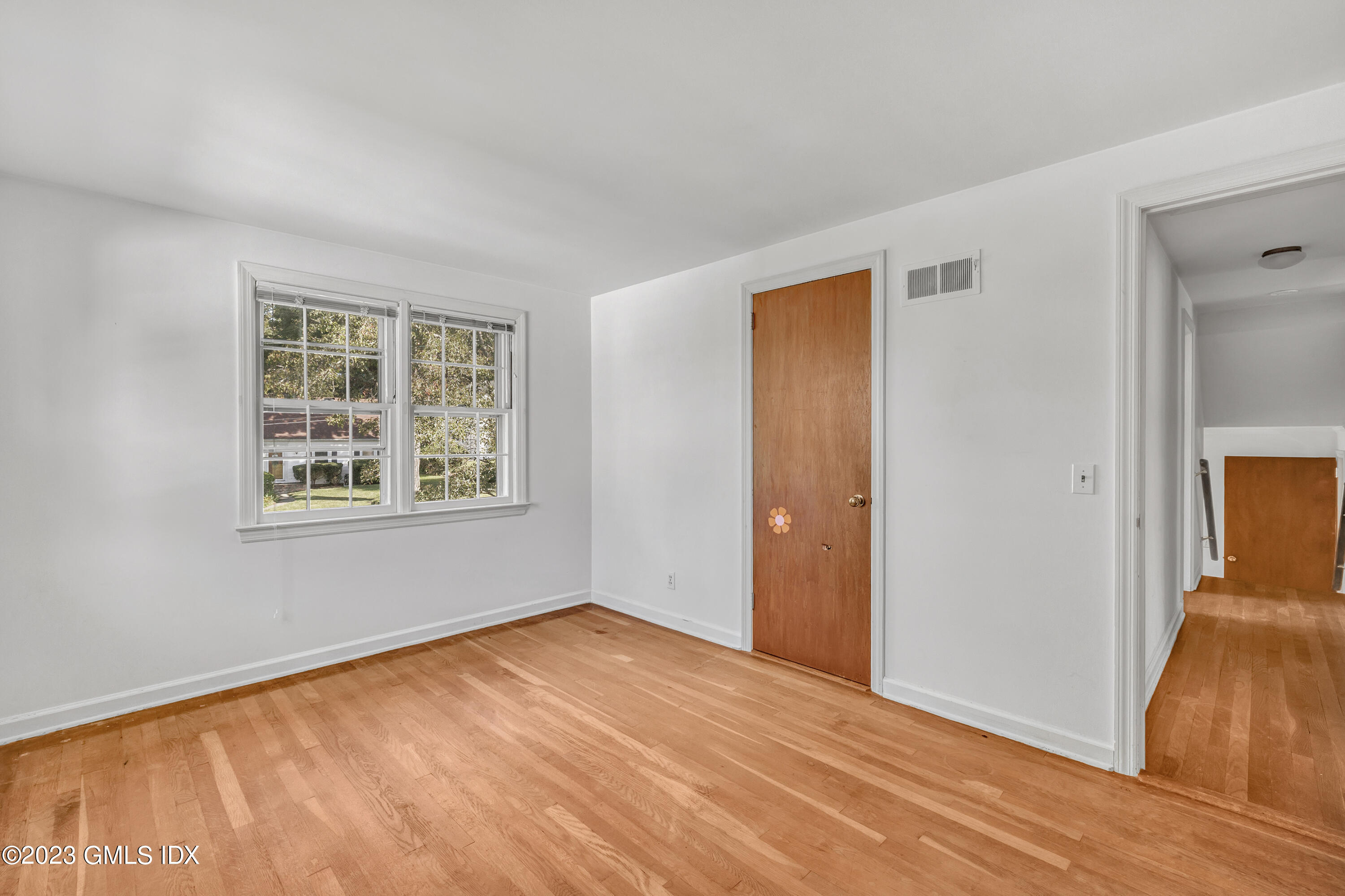 20 Bayside Terrace Riverside, CT 06878 - Photo 19 of 30 an empty room with wooden floor and windows
