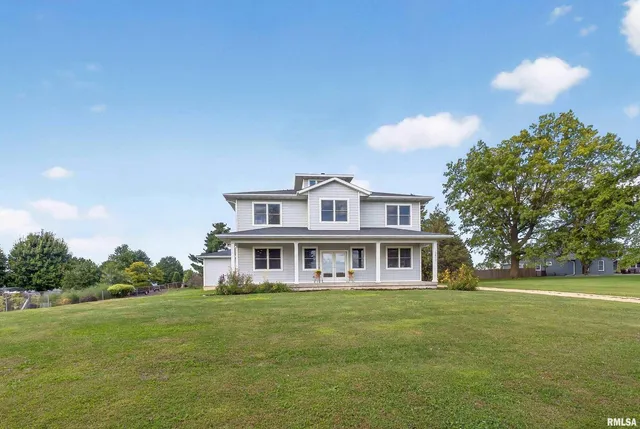 a house view with swimming pool and garden space