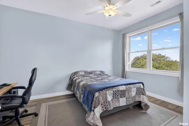 a view of an empty room with kitchen and a window