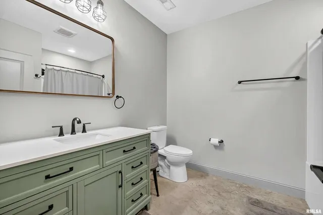 a living room with furniture and a gym