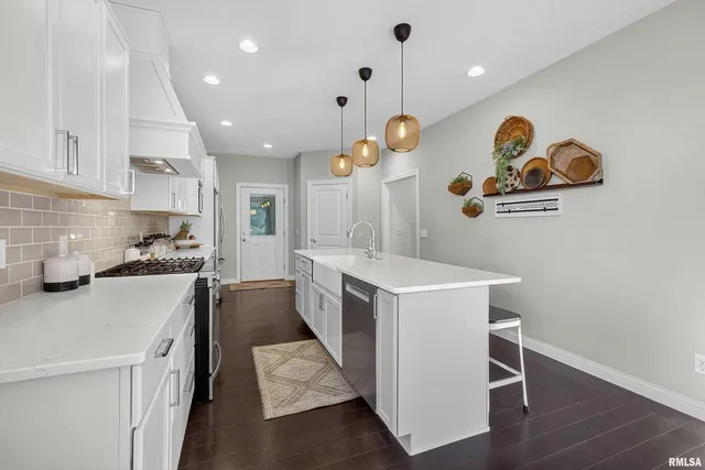 a kitchen with a sink and a stove top oven