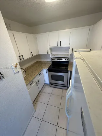 a view of a kitchen with microwave and cabinets