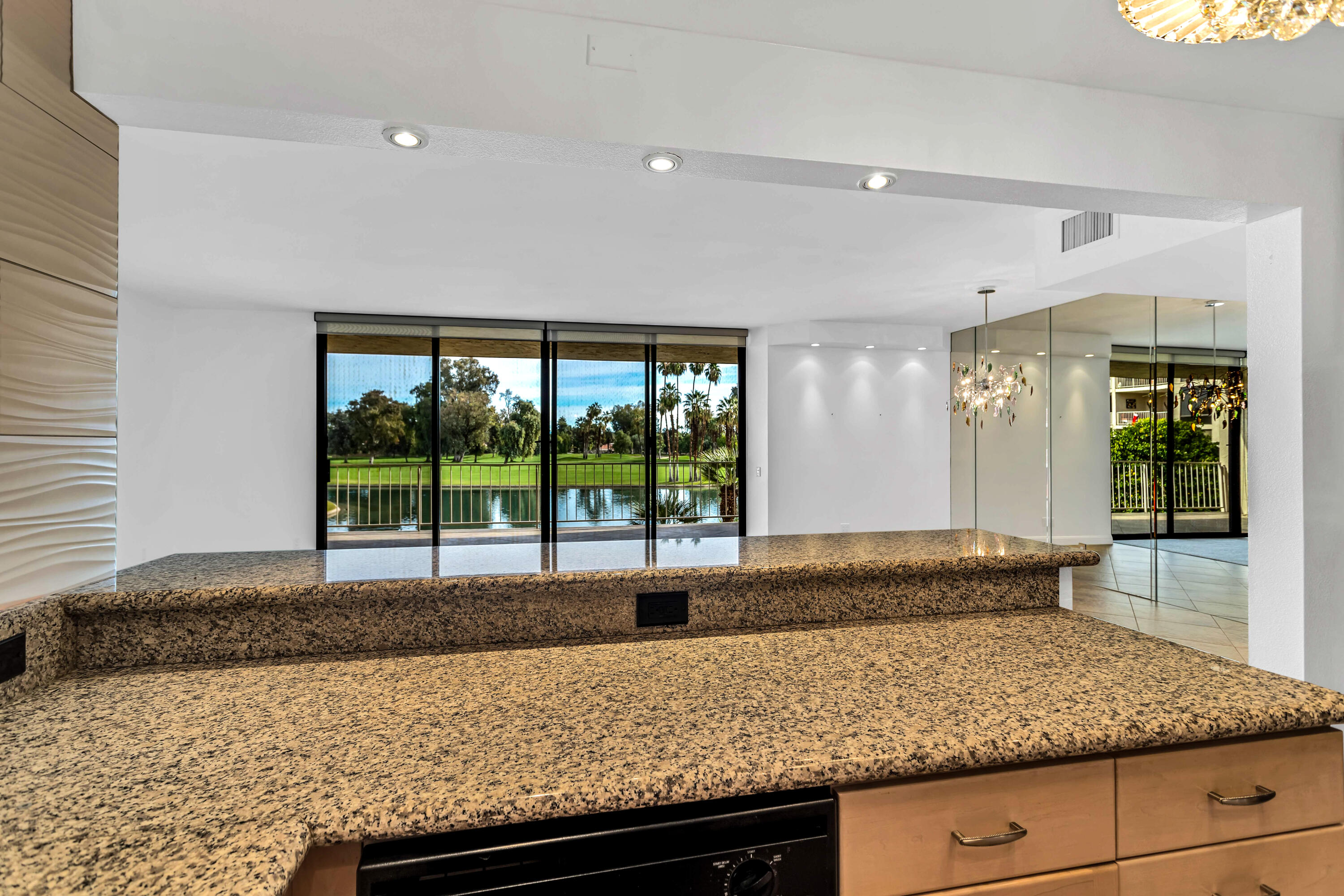910 Island Drive, Unit 211 Rancho Mirage, CA 92270 - Photo 11 of 38 a kitchen with a sink and large window