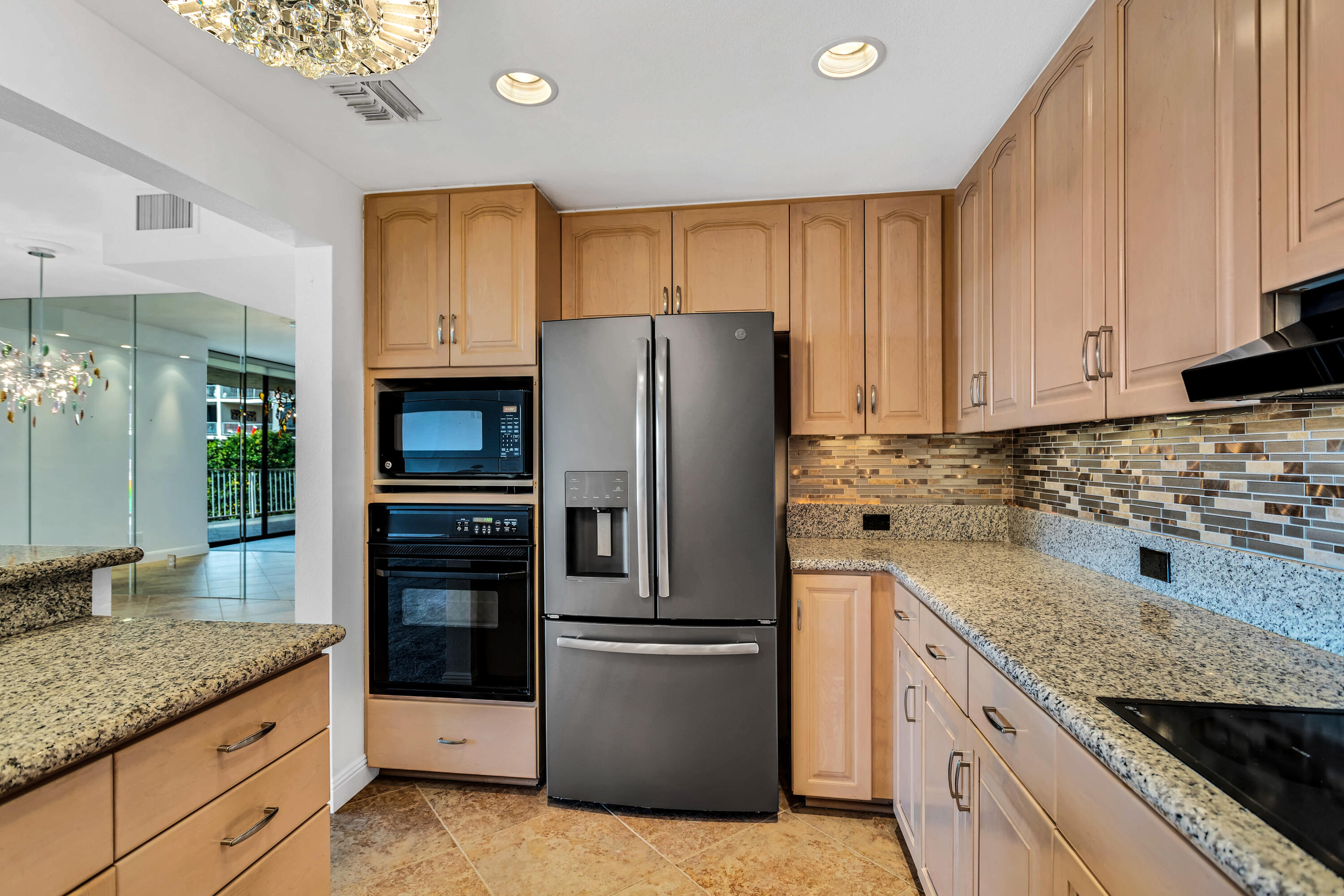 910 Island Drive, Unit 211 Rancho Mirage, CA 92270 - Photo 12 of 38 a kitchen with granite countertop a refrigerator stove and oven