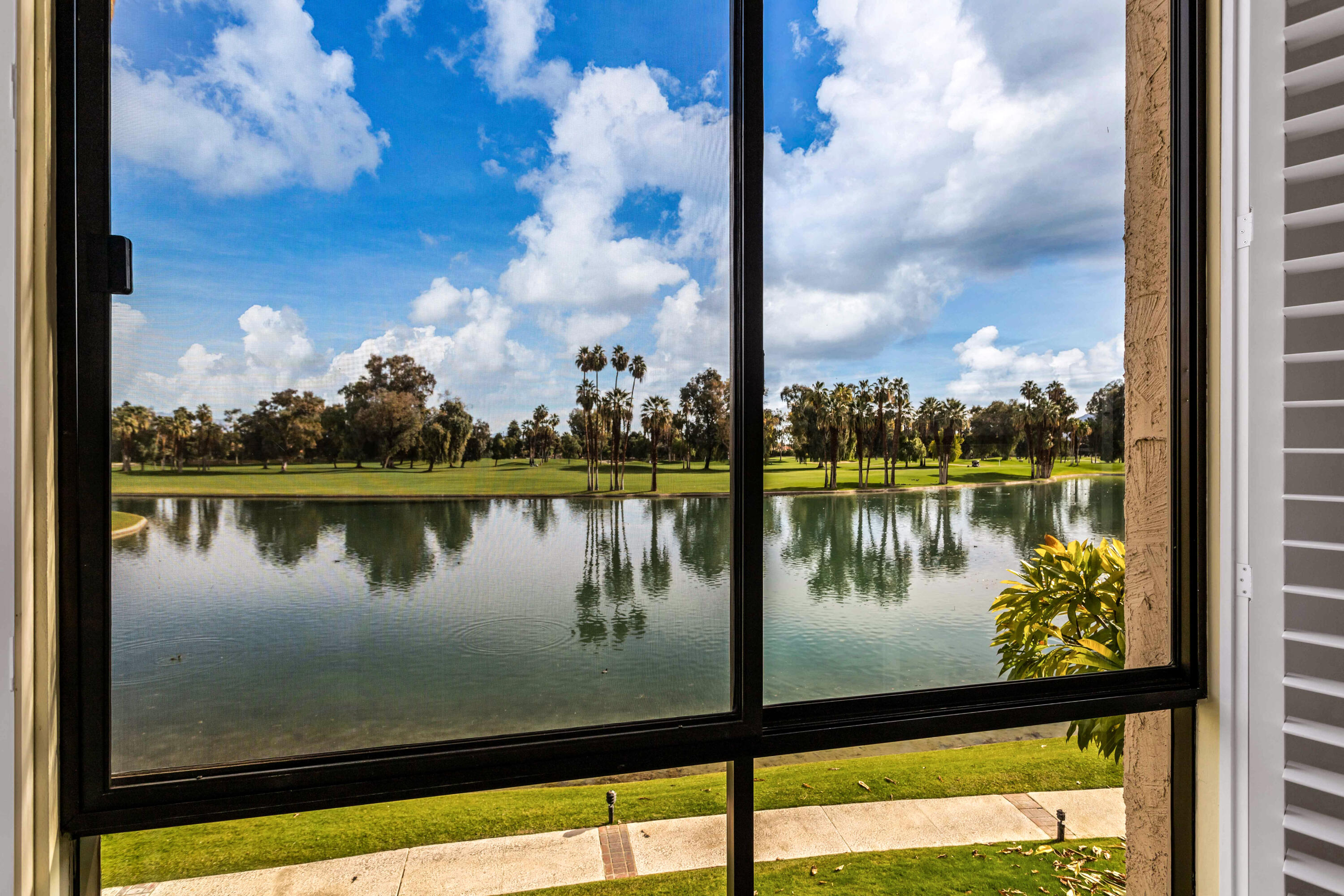 910 Island Drive, Unit 211 Rancho Mirage, CA 92270 - Photo 17 of 38 a view of a lake from a balcony