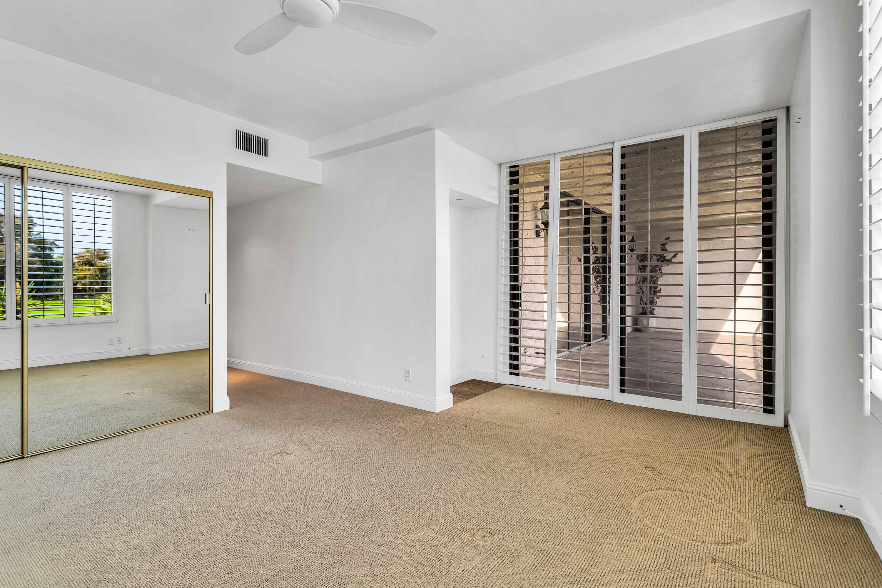910 Island Drive, Unit 211 Rancho Mirage, CA 92270 - Photo 21 of 38 an empty room with windows