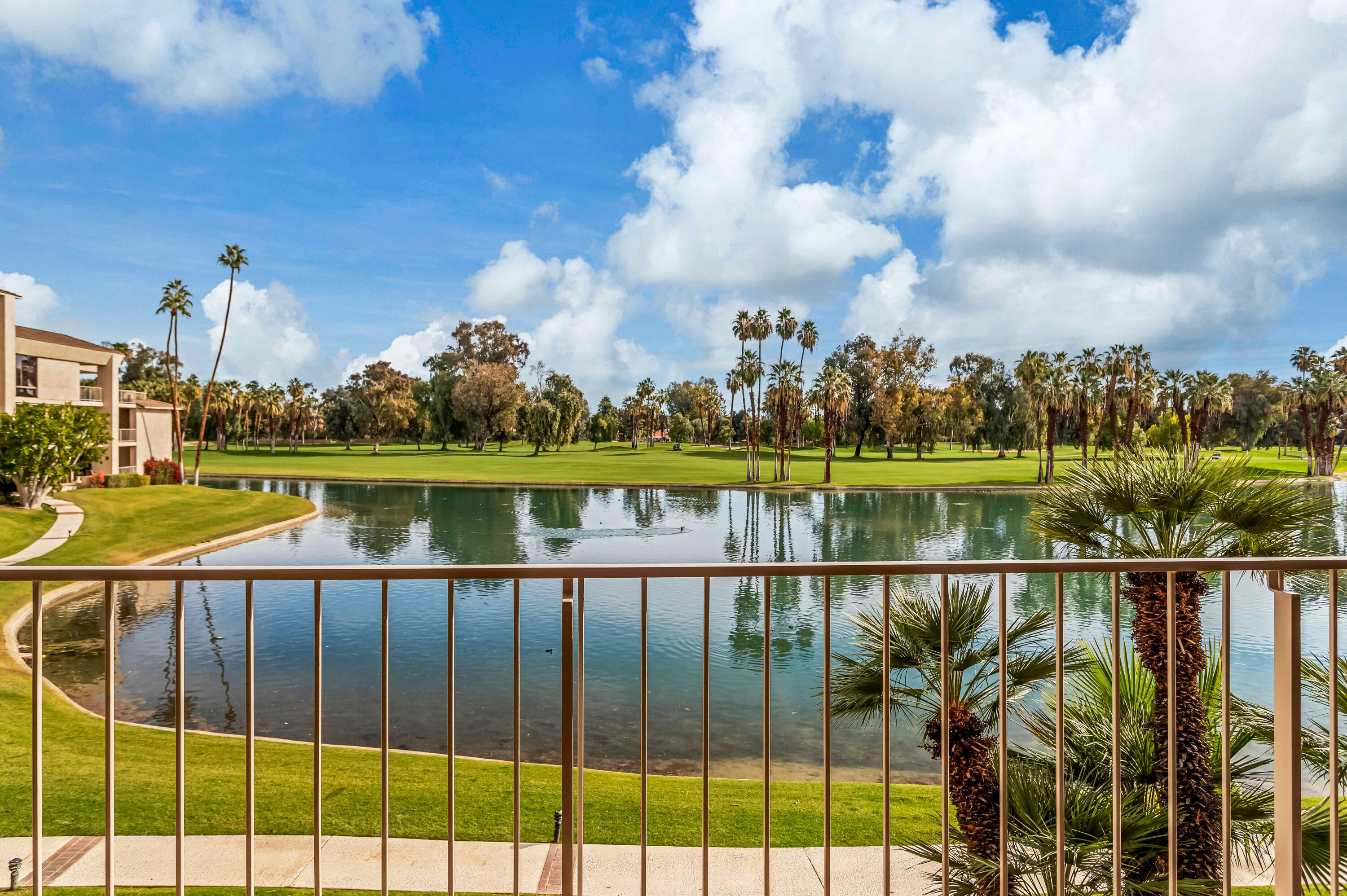 910 Island Drive, Unit 211 Rancho Mirage, CA 92270 - Photo 23 of 38 a view of a lake with a city from a lake
