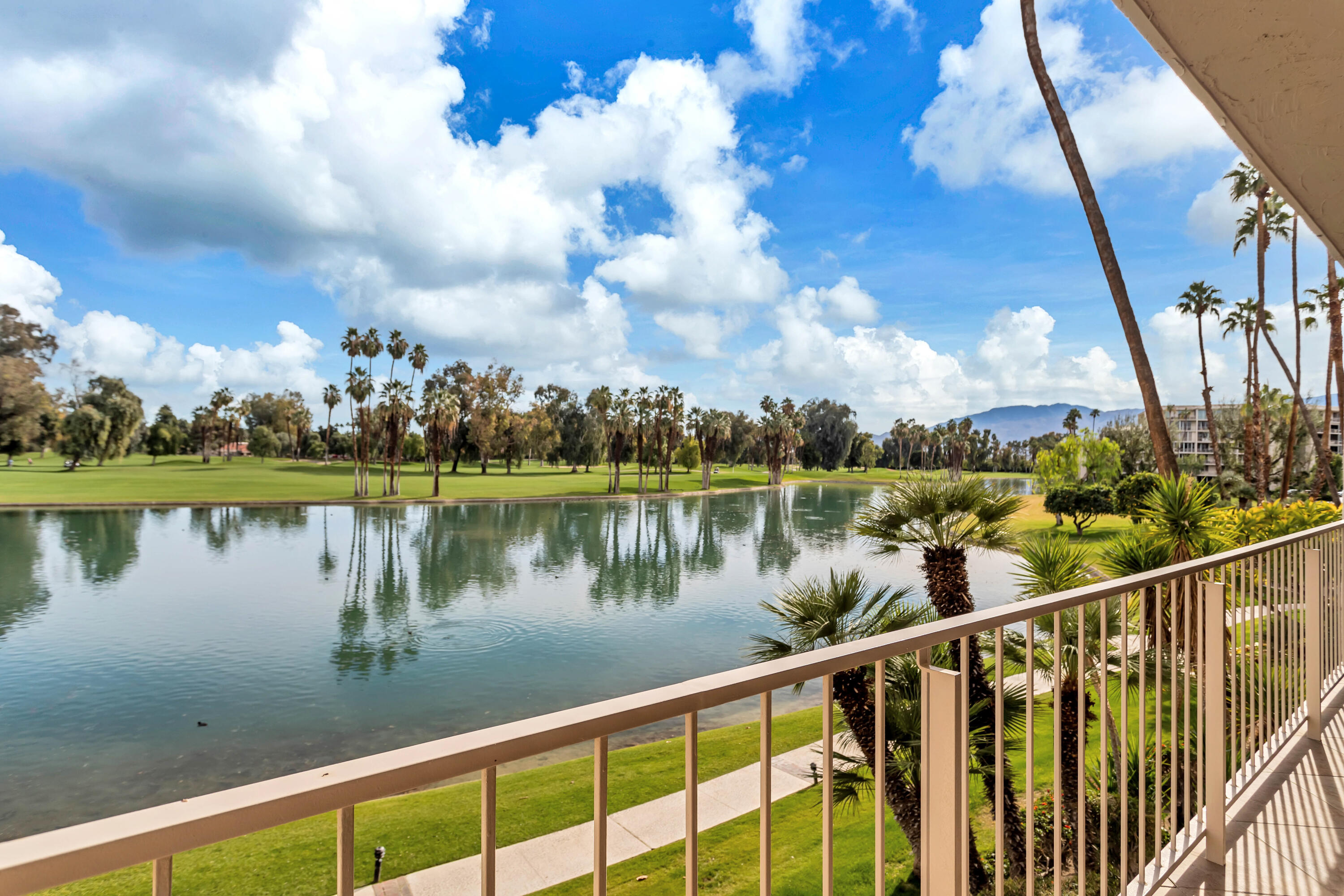 910 Island Drive, Unit 211 Rancho Mirage, CA 92270 - Photo 24 of 38 a view of a lake from a balcony