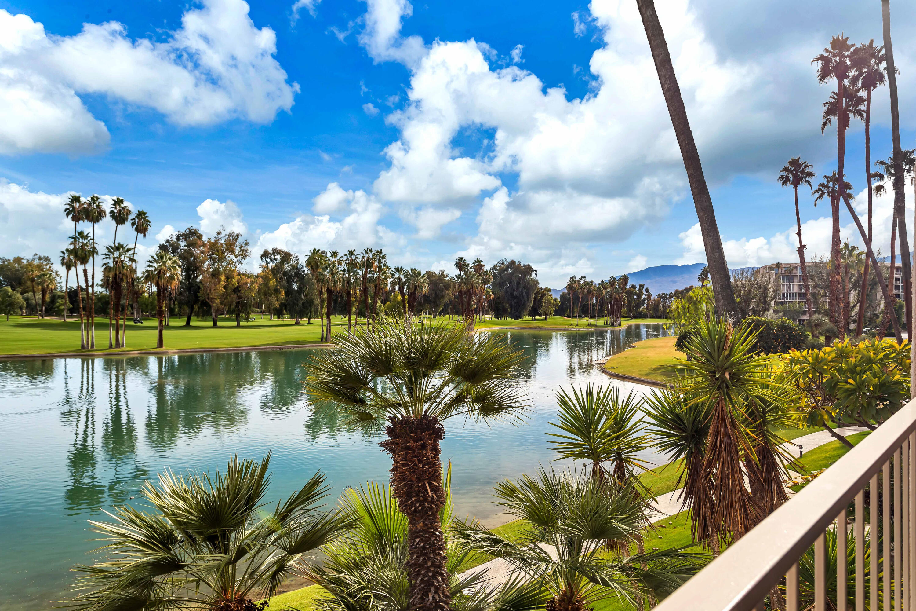 910 Island Drive, Unit 211 Rancho Mirage, CA 92270 - Photo 3 of 38 a view of a lake in a residential house with outdoor space and lake view