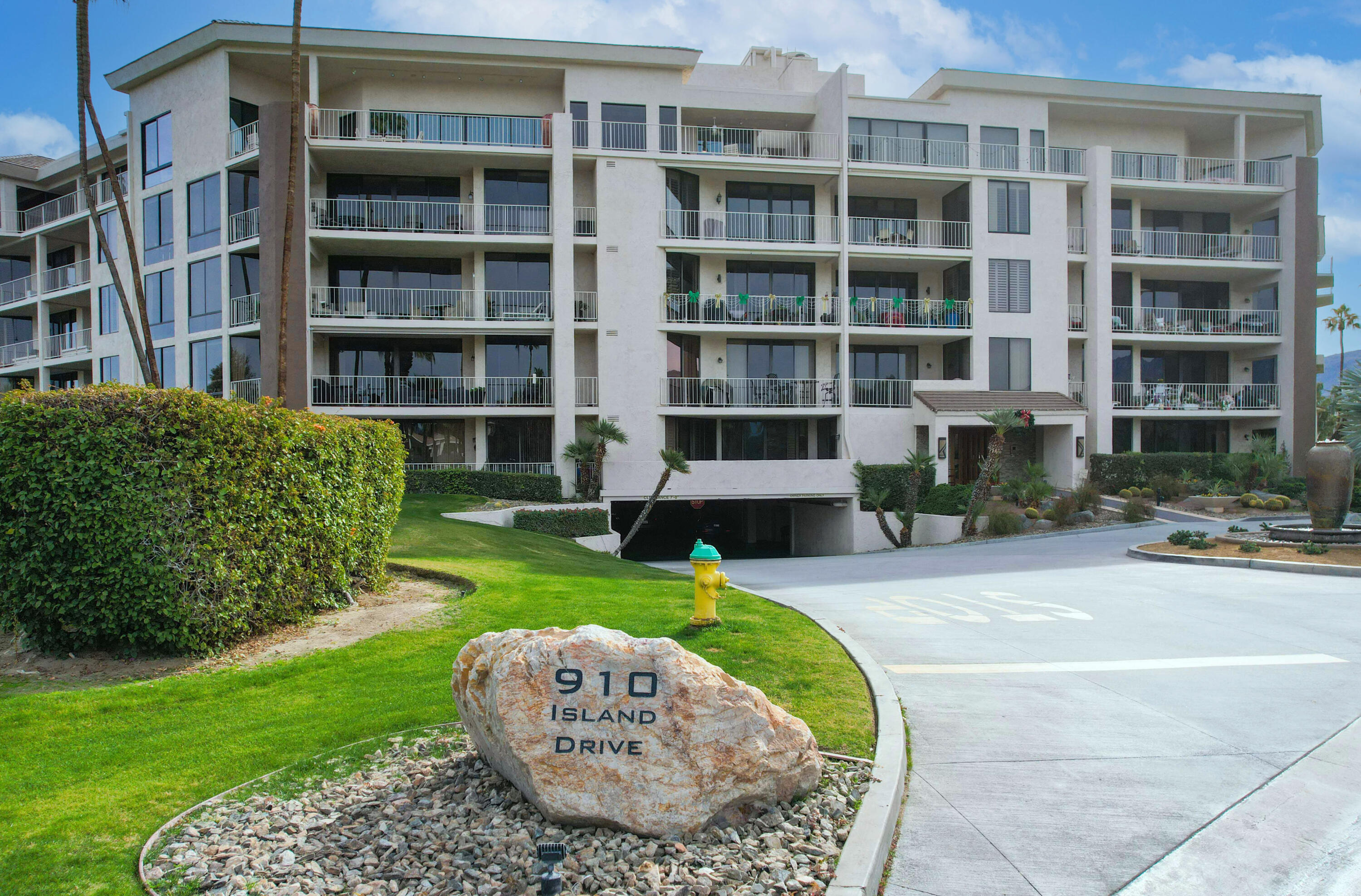 910 Island Drive, Unit 211 Rancho Mirage, CA 92270 - Photo 32 of 38 a view of a house with a yard fire pit and outdoor seating